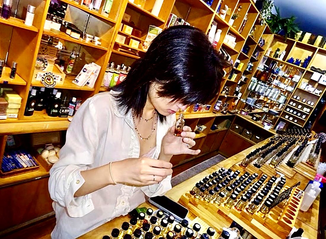 A guest smelling a fragrance oil at the blending bar
