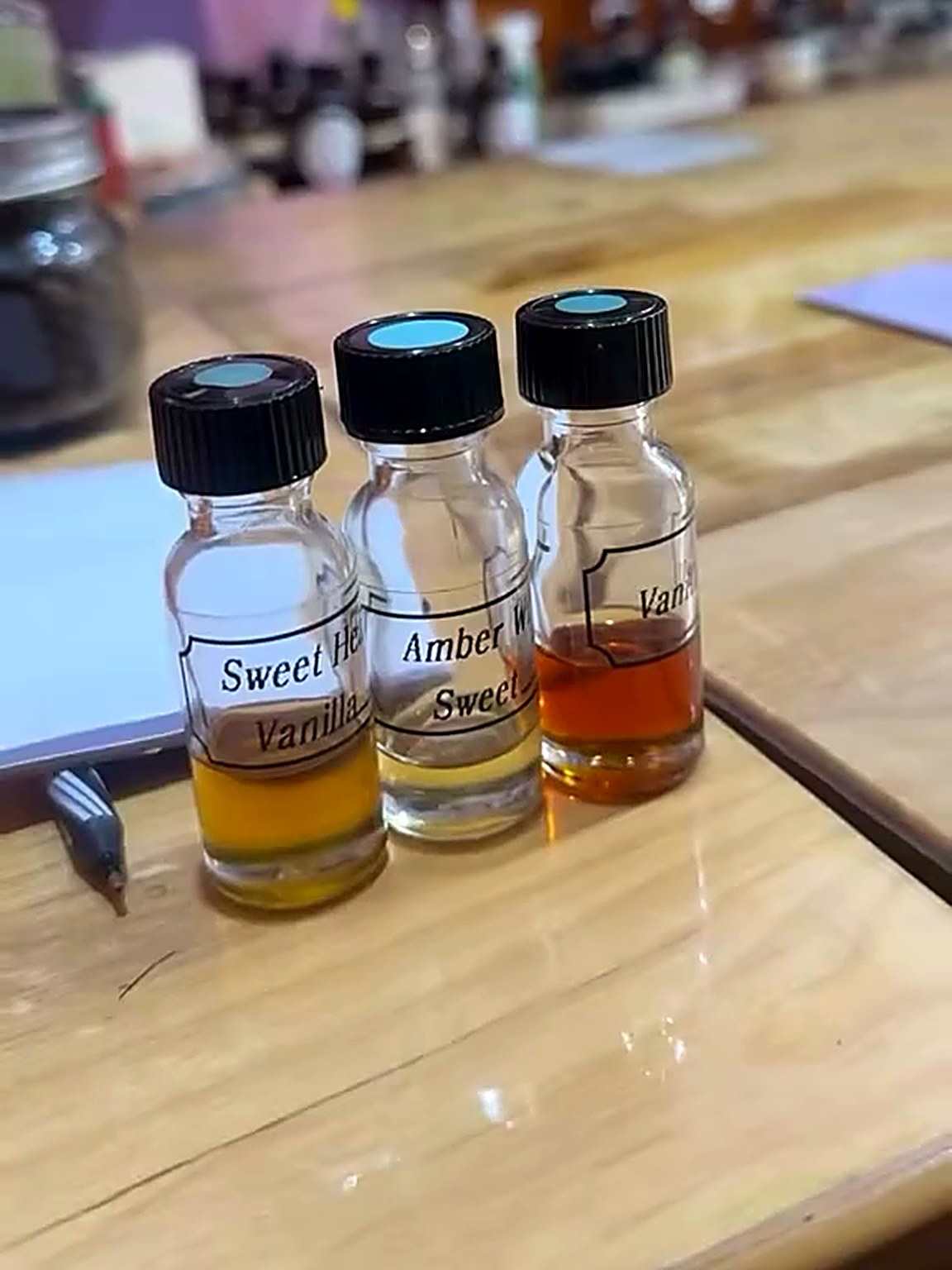 Three chosen fragrance oils lined up on the wooden blending bar